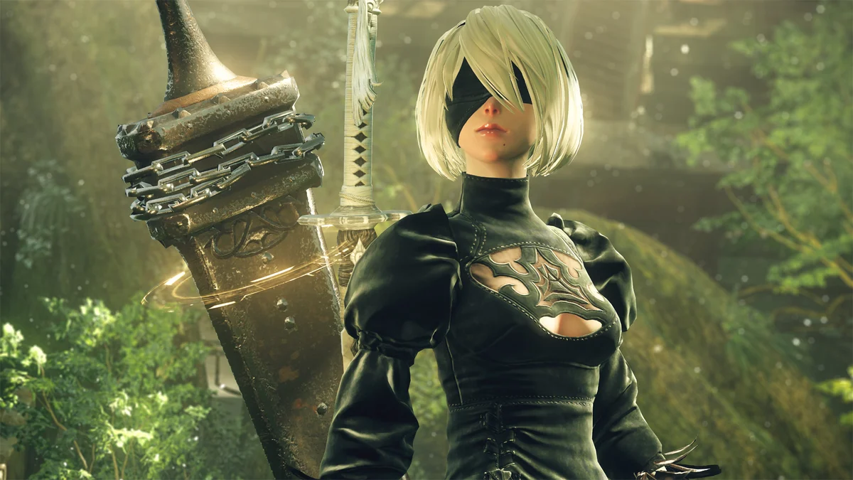 2B beside her Pod in an overgrown area of NieR:Automata.