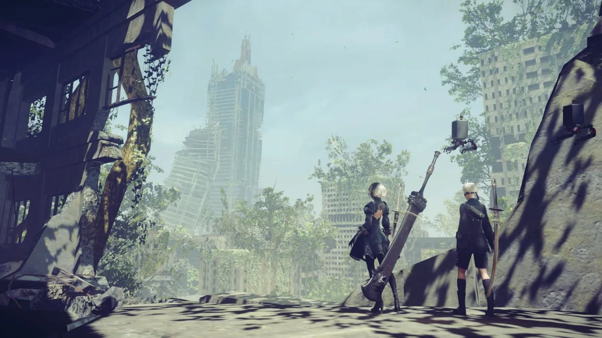 2B and 9S standing in the overgrown city in NieR:Automata The End of YoRHa Edition.