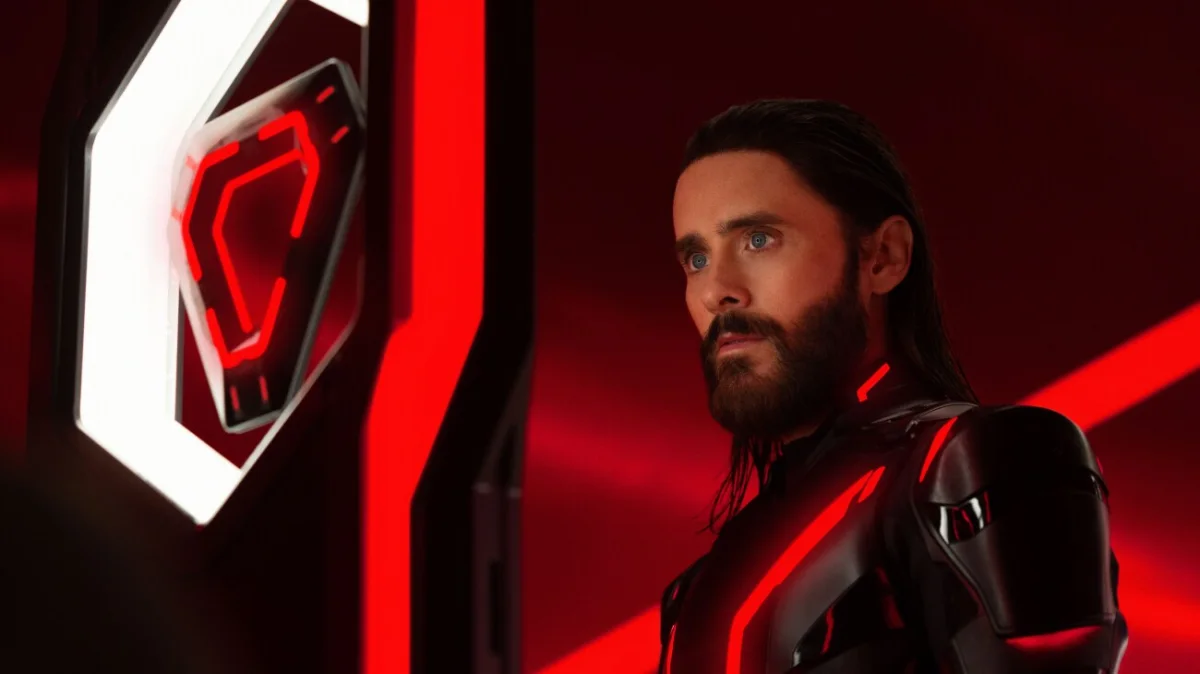 Ares in a black suit with red illuminated lines in Tron: Ares.
